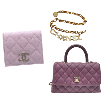 Pink quilted Chanel wallet, a gold chain bracelet with 'CHANEL' lettering, and a purple quilted Chanel handbag.
